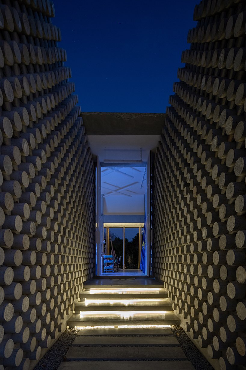 bamboo battens and discarded concrete spacers envelope art studio by 11.29 studio in thailand