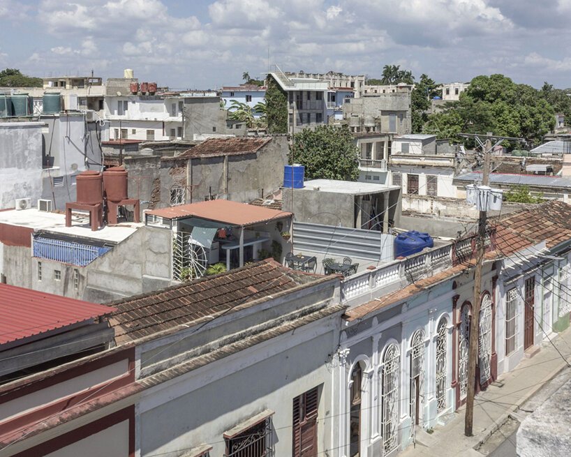 a lush garden grows the entire height of albor arquitectos’tower house in cuba