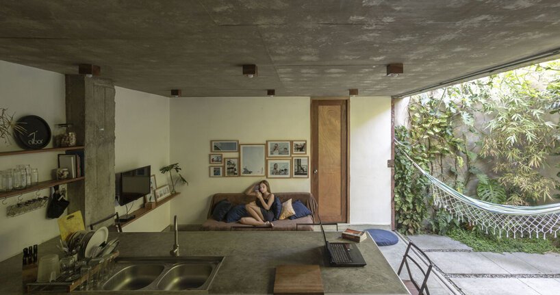 a lush garden grows the entire height of albor arquitectos’tower house in cuba