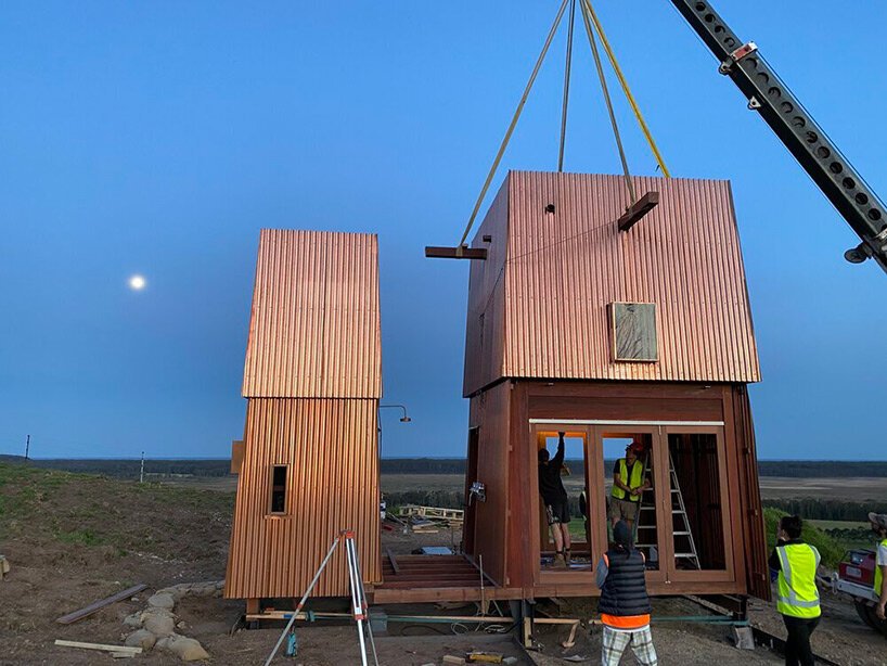 casey brown sets copper-clad cabin with movable awnings within lush australian paddocks