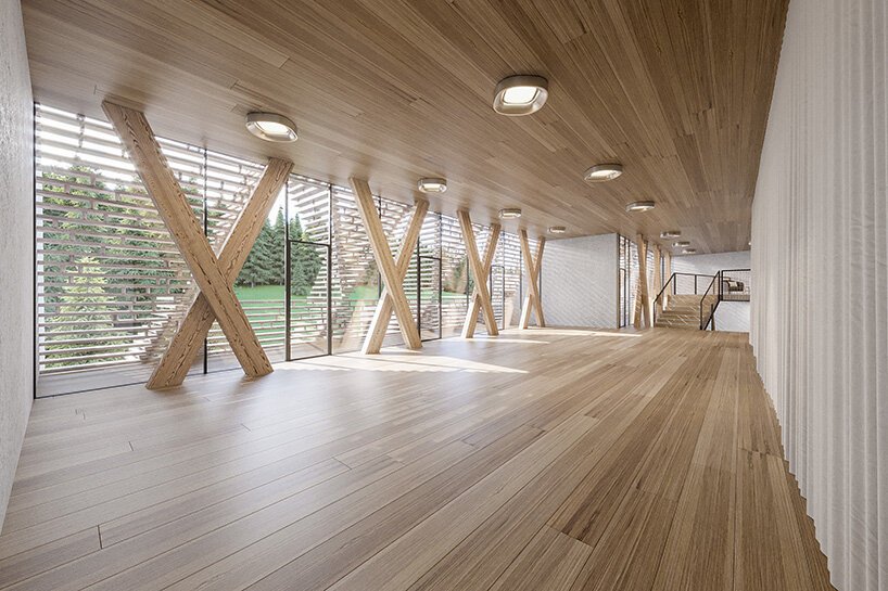 a stack of timber A-frames by enota architects to extend slovenia’s hotel natura