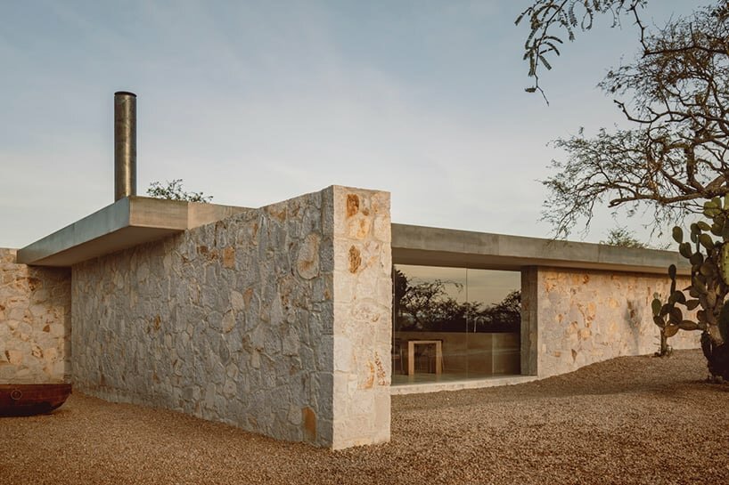 dispersed stone volumes and alleys develop a cruciform residential plan in mexico