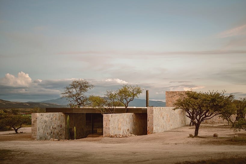 dispersed stone volumes and alleys develop a cruciform residential plan in mexico