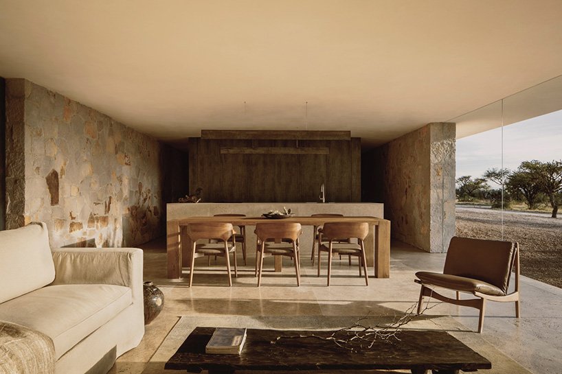 dispersed stone volumes and alleys develop a cruciform residential plan in mexico