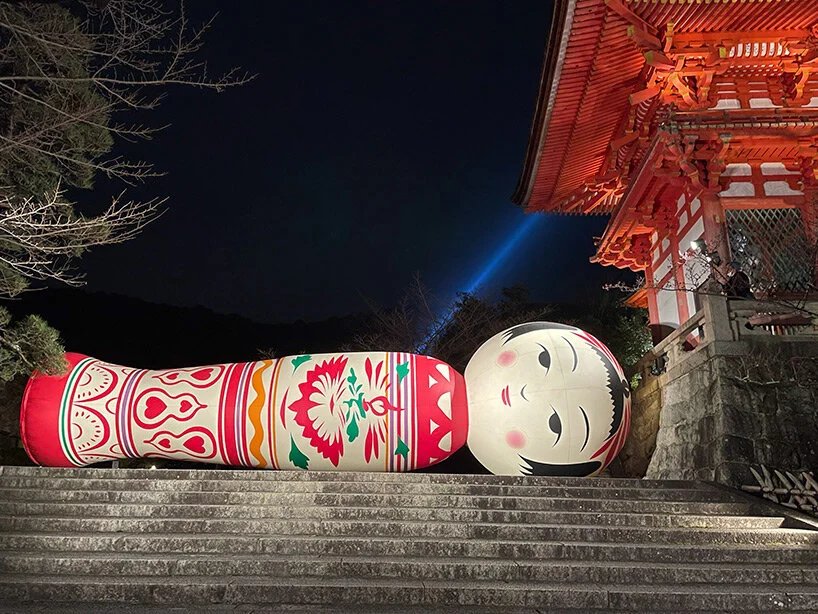 giant kokeshi doll welcomes visitors to historic kiyomizu-dera temple in kyoto