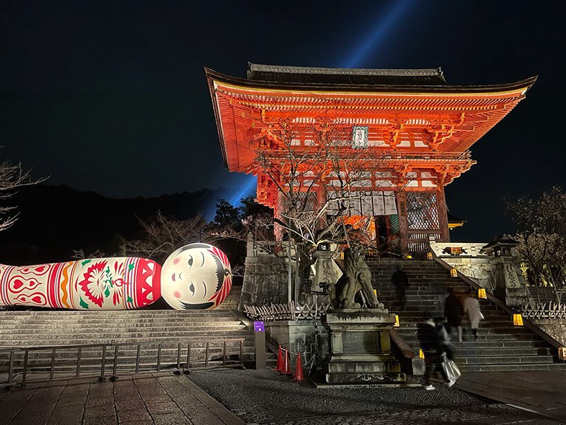 giant kokeshi doll welcomes visitors to historic kiyomizu-dera temple in kyoto