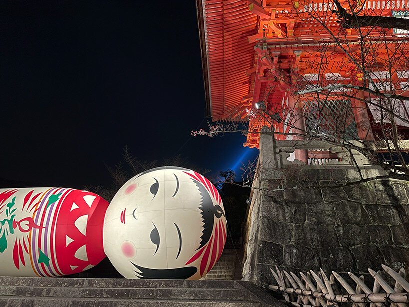 giant kokeshi doll welcomes visitors to historic kiyomizu-dera temple in kyoto
