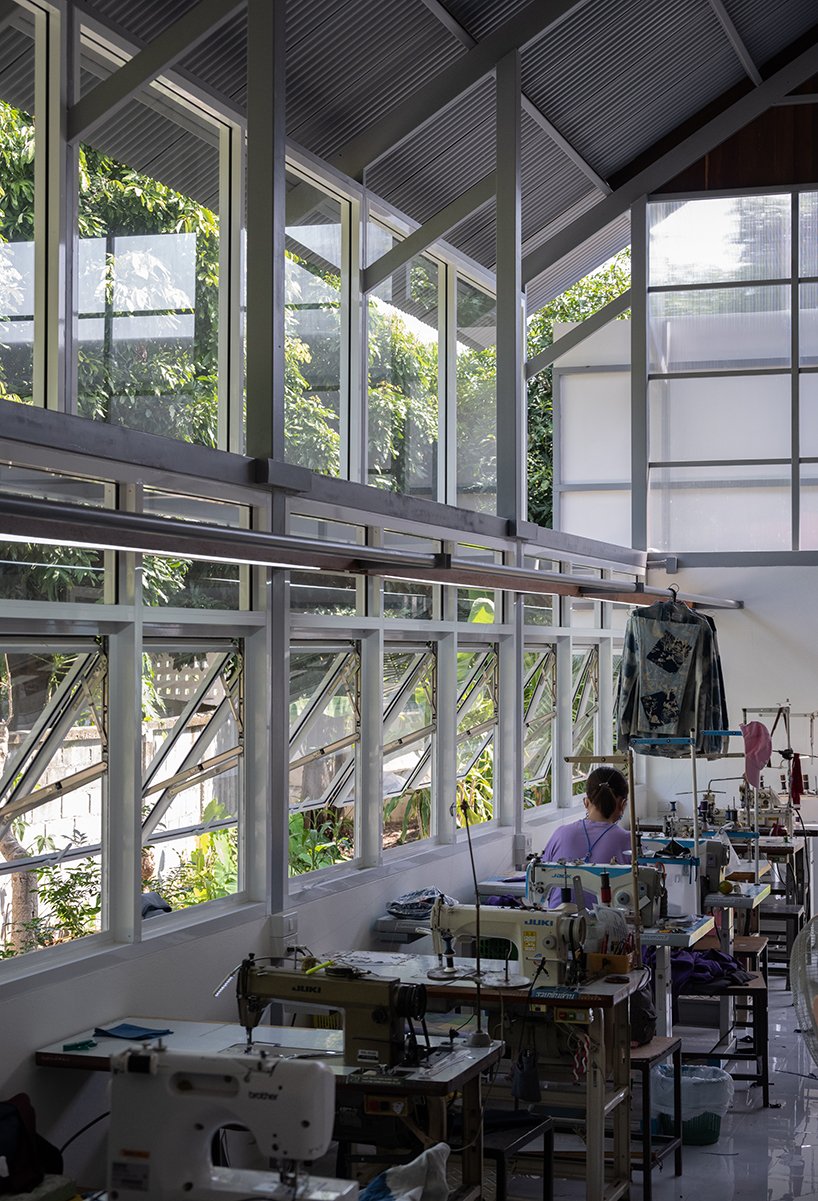 sher maker tops pleated wood longhouse with steel roof for fashion studio in chiang mai