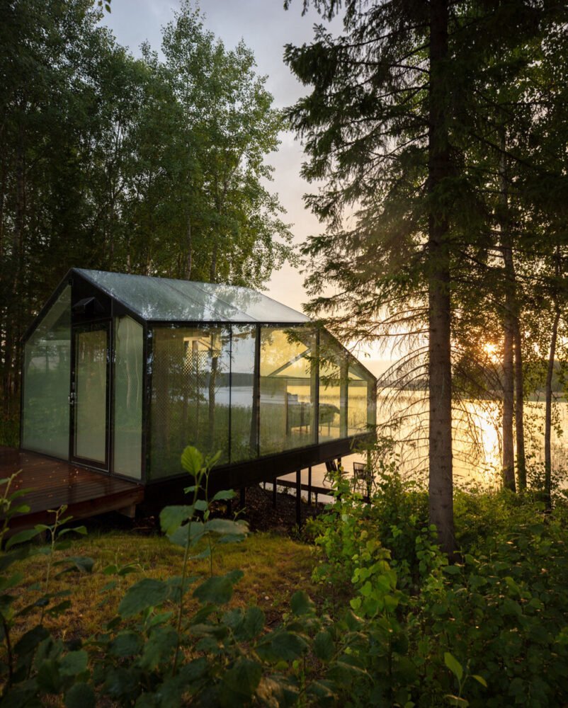 mirrored glass cabin with panoramic views disappears into finland’s rich natural landscape