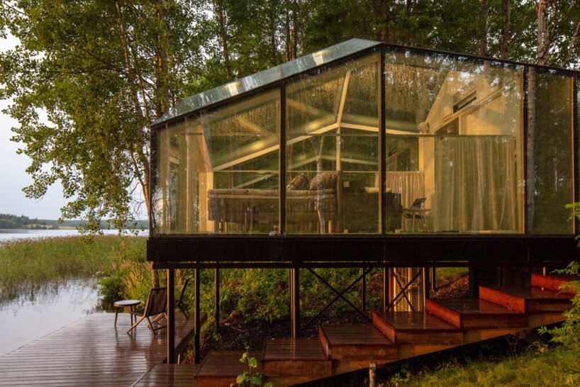 mirrored glass cabin with panoramic views disappears into finland’s rich natural landscape
