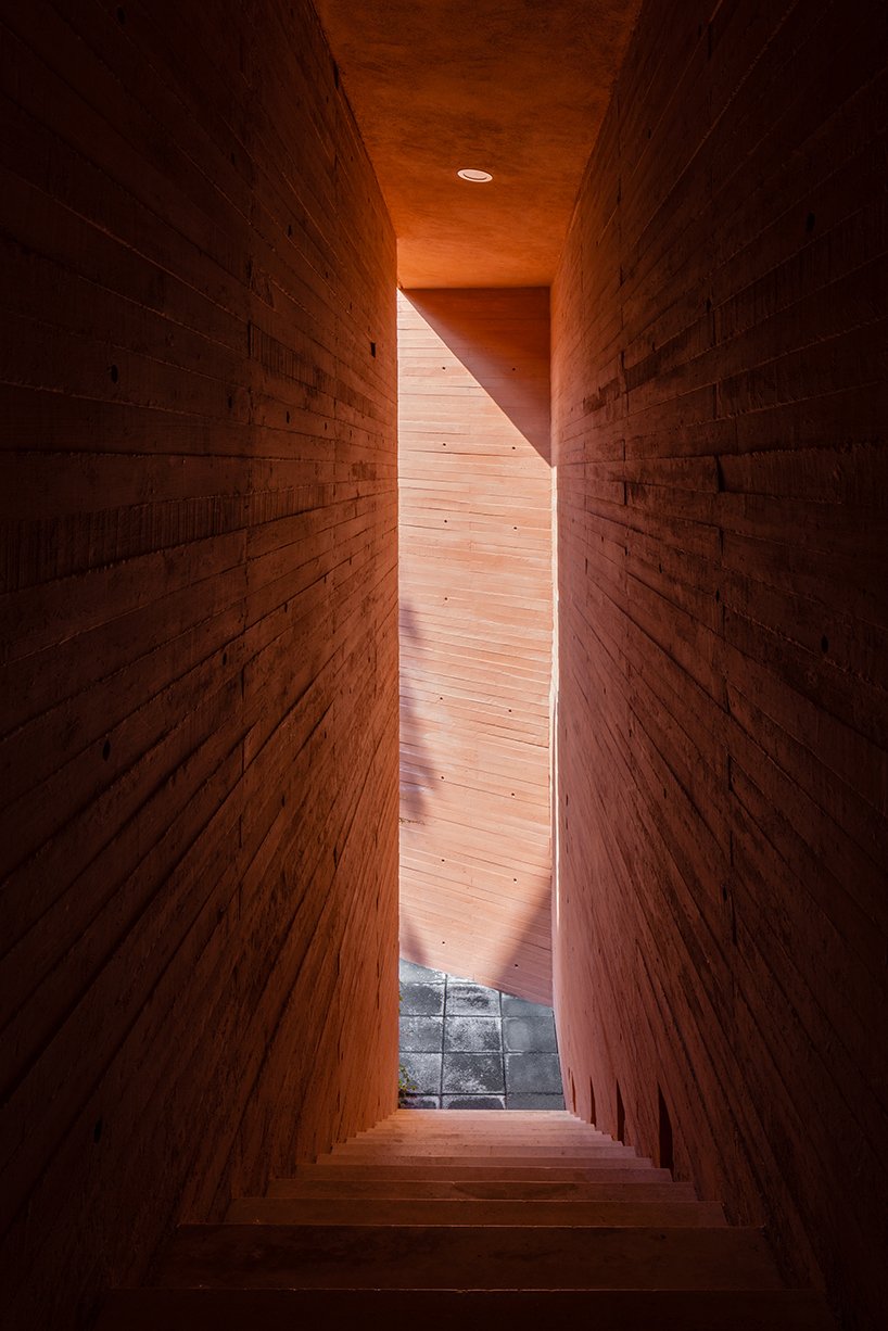 orange-tinted concrete blocks subtly stack residential complex in mexico