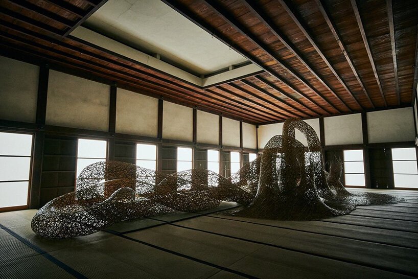 tanabe chikuunsai IV weaves bamboo into massive works that emerge from walls