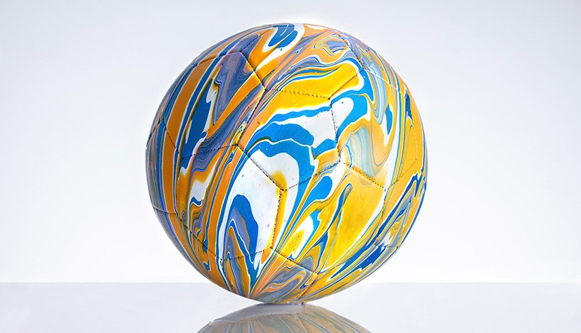 fusion paint-pouring turns national football strips into colorful marbled balls