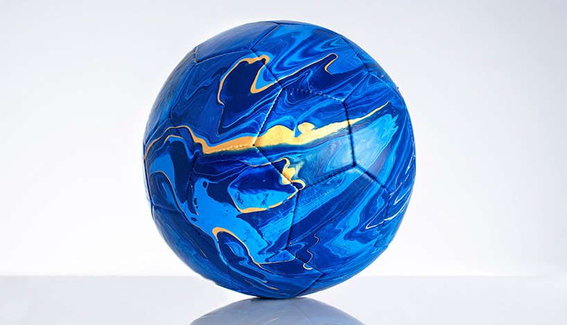 fusion paint-pouring turns national football strips into colorful marbled balls