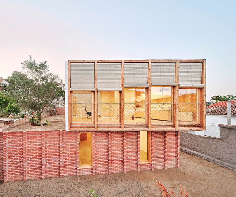 ágora arquitectura stacks cross laminated timber house atop old brick base in spain