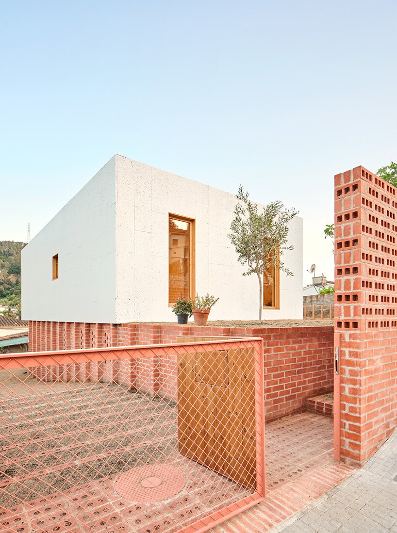 ágora arquitectura stacks cross laminated timber house atop old brick base in spain