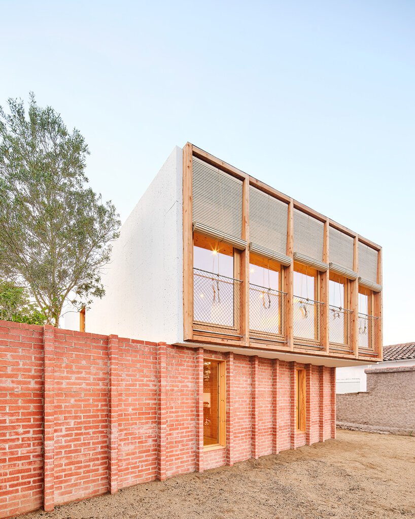 ágora arquitectura stacks cross laminated timber house atop old brick base in spain