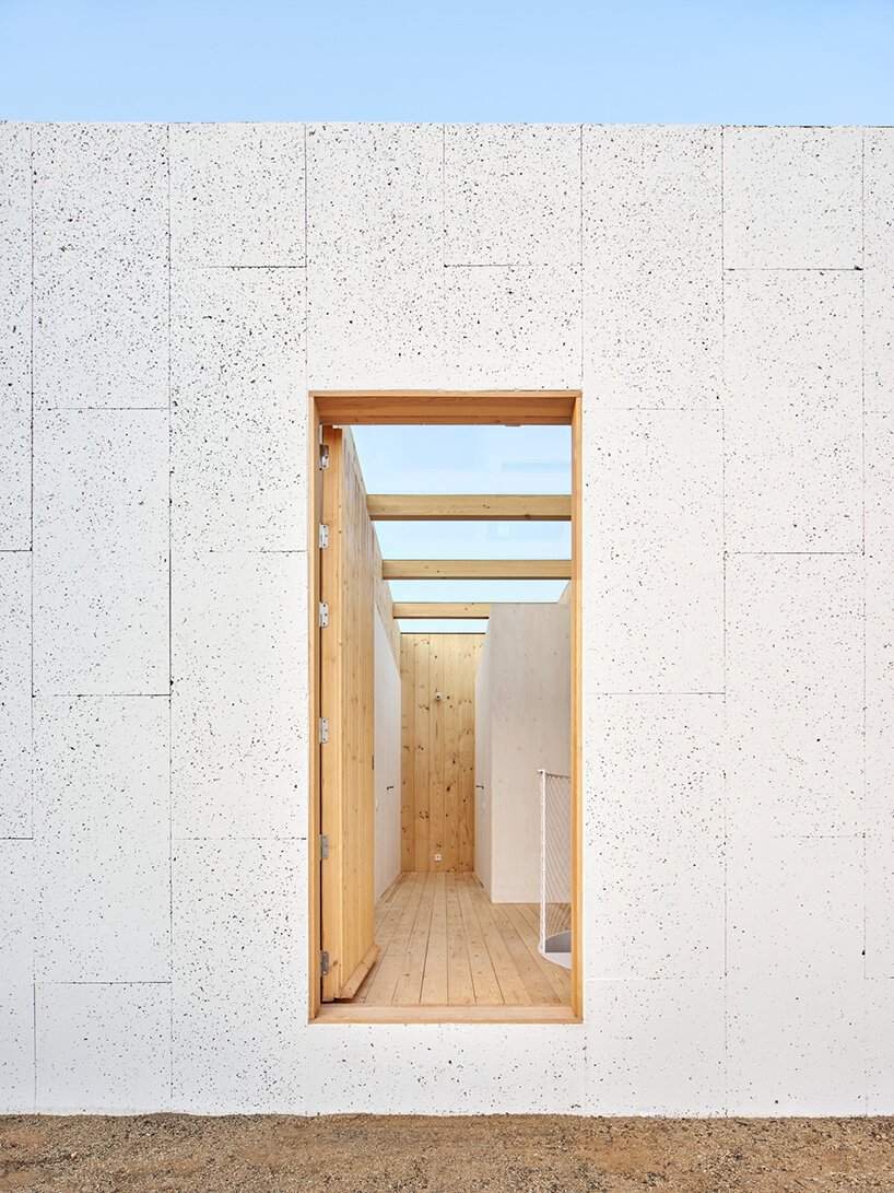 ágora arquitectura stacks cross laminated timber house atop old brick base in spain