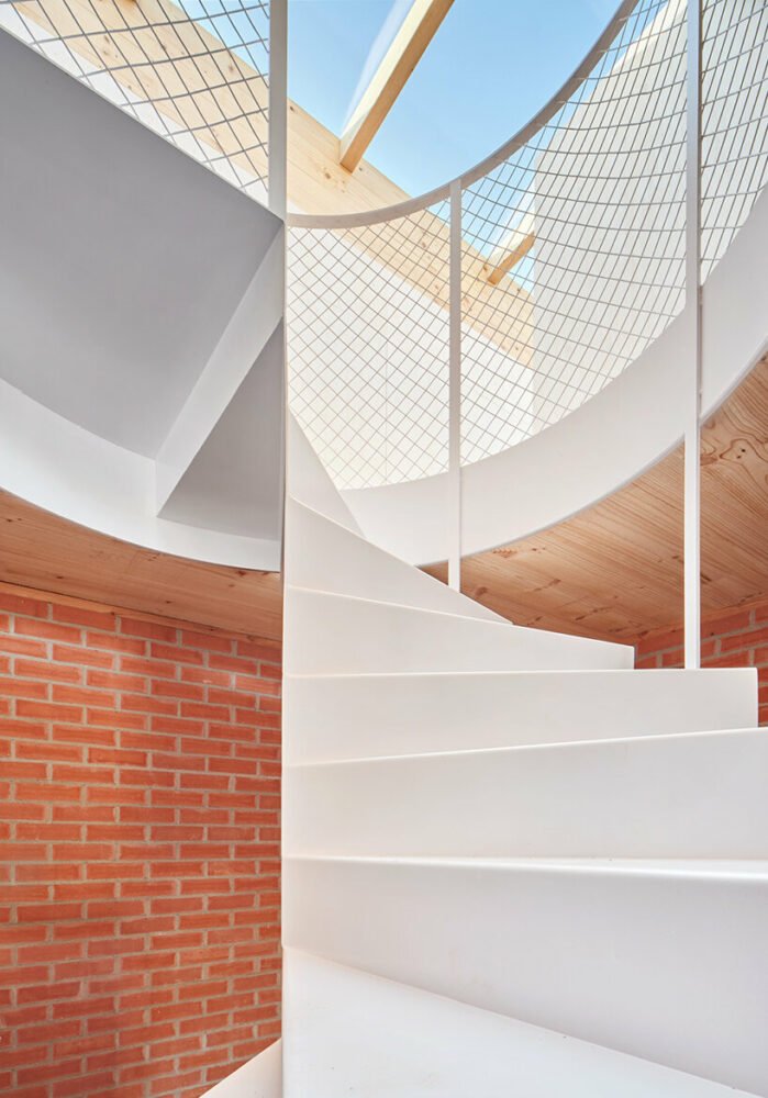 ágora arquitectura stacks cross laminated timber house atop old brick base in spain