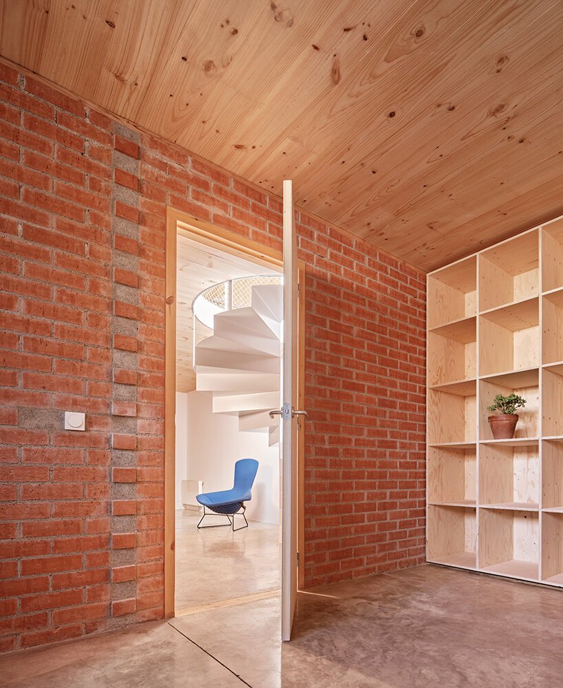 ágora arquitectura stacks cross laminated timber house atop old brick base in spain